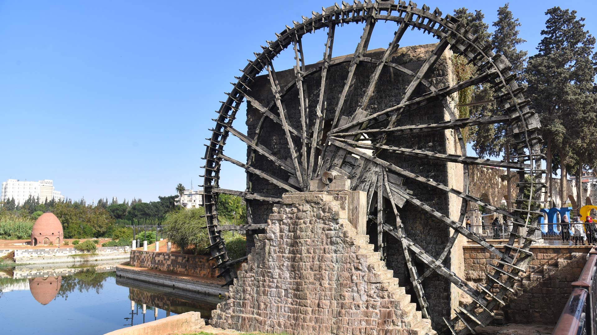 A photograph immortalizes the Norias of Hama, as these iconic waterwheels gracefully spin against the city's skyline.
