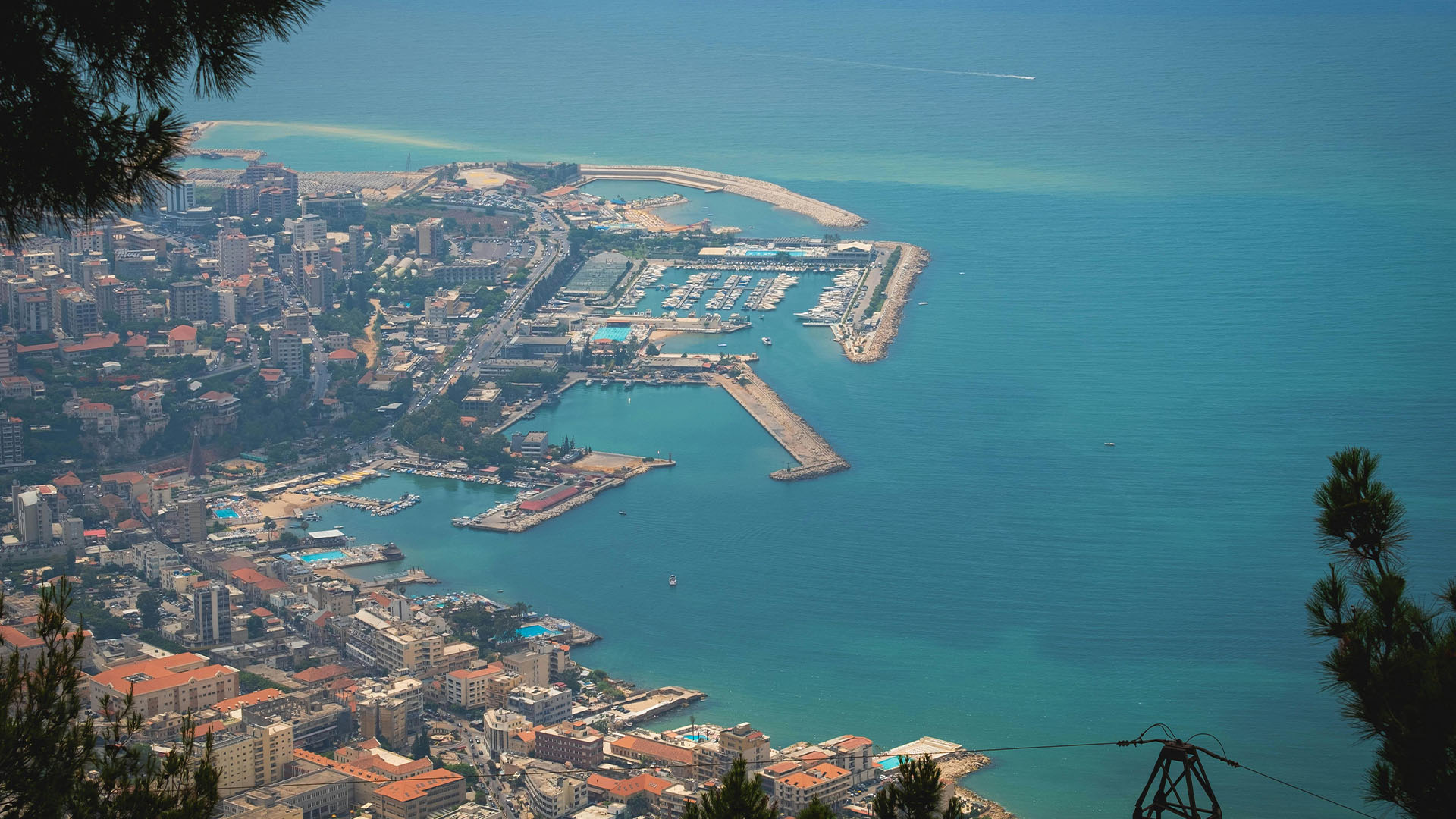 Travel to Lebanon: An aerial photograph unveils the breathtaking coastline of Beirut, as it gracefully meets the shimmering waters of the Mediterranean Sea, presenting a picturesque vista that captivates the senses.