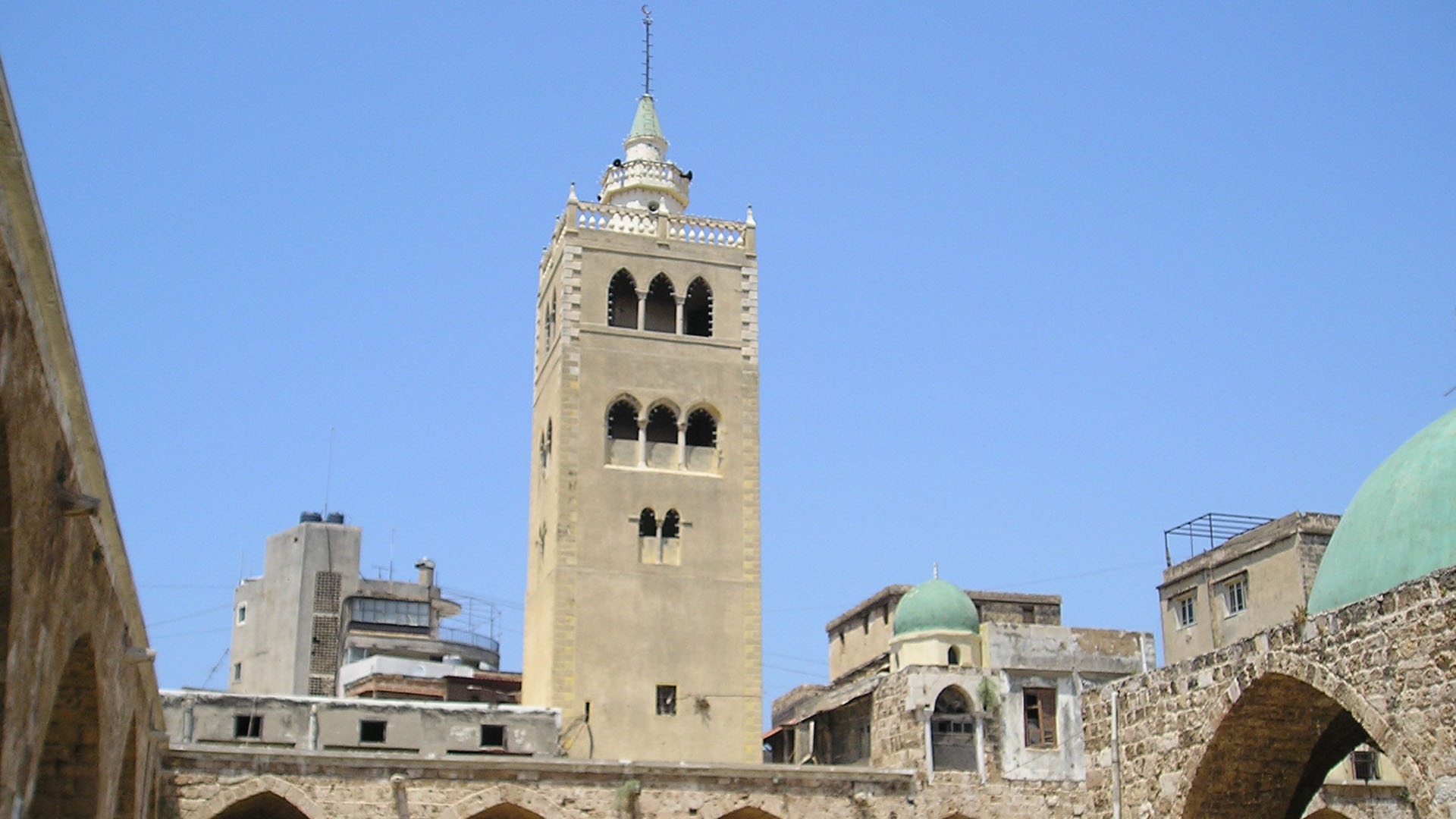 A photograph highlights the majestic minaret of the Great Mosque in Tripoli, serving as a testament to its stature as one of Lebanon's largest mosques.