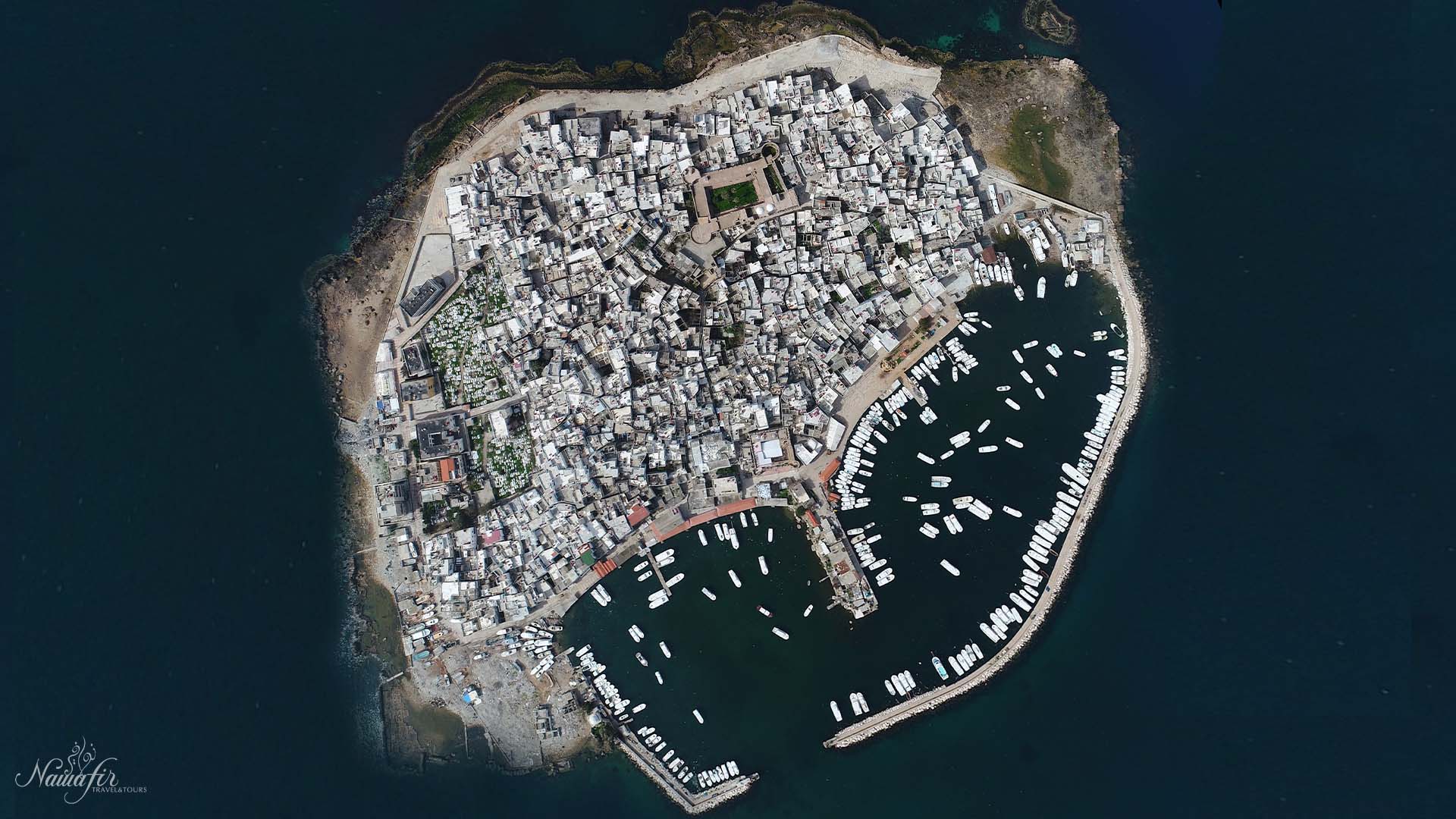 From an aerial vantage point, a photograph captures the enchanting Arwad Island, the only inhabited island in Syria, gracefully positioned off the coast of Tartous.
