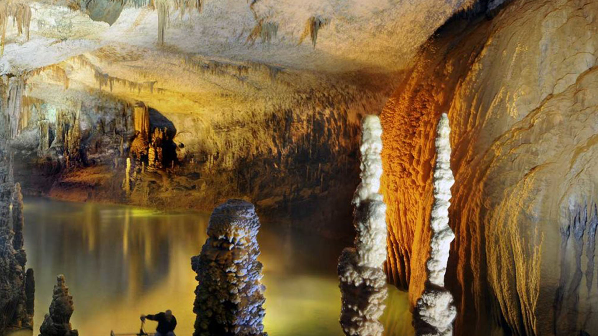 A photograph reveals the mesmerizing beauty of Jeita Grotto, showcasing its intricate limestone formations and the hidden marvels that lie beneath the surface.