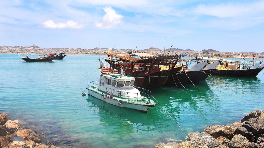 A panoramic photograph immortalizes the awe-inspiring Masirah Island, where boats gracefully appears in the background, enhancing the natural splendour of the scene.